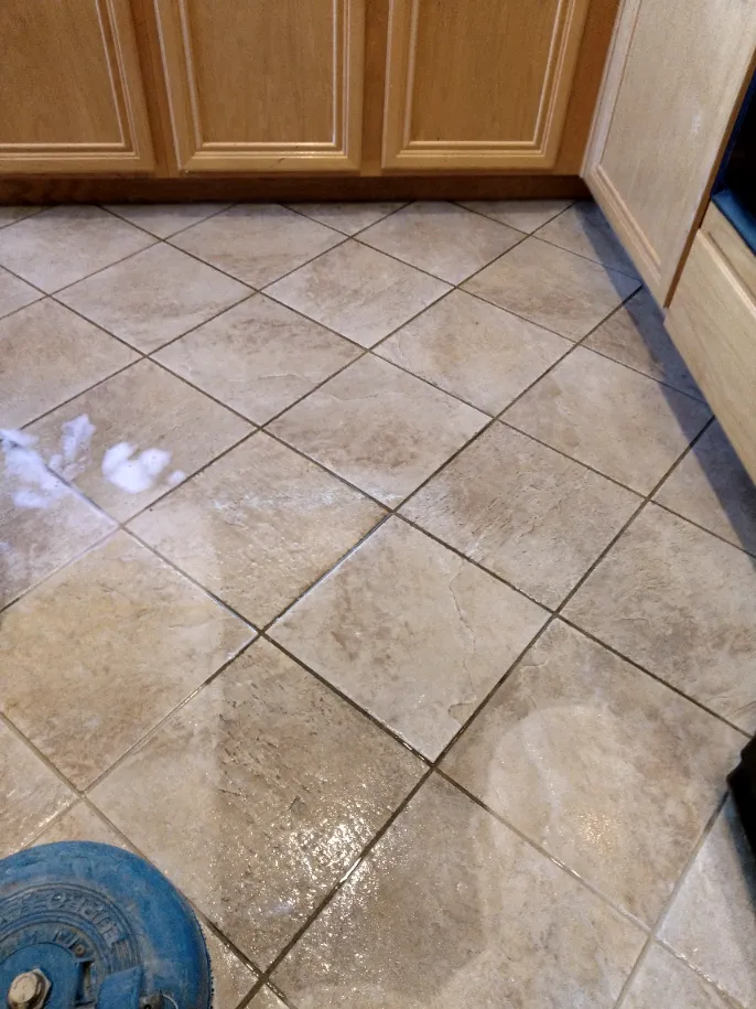 Experts cleaning travertine tiles in Jurupa Valley using professional rotary tools
