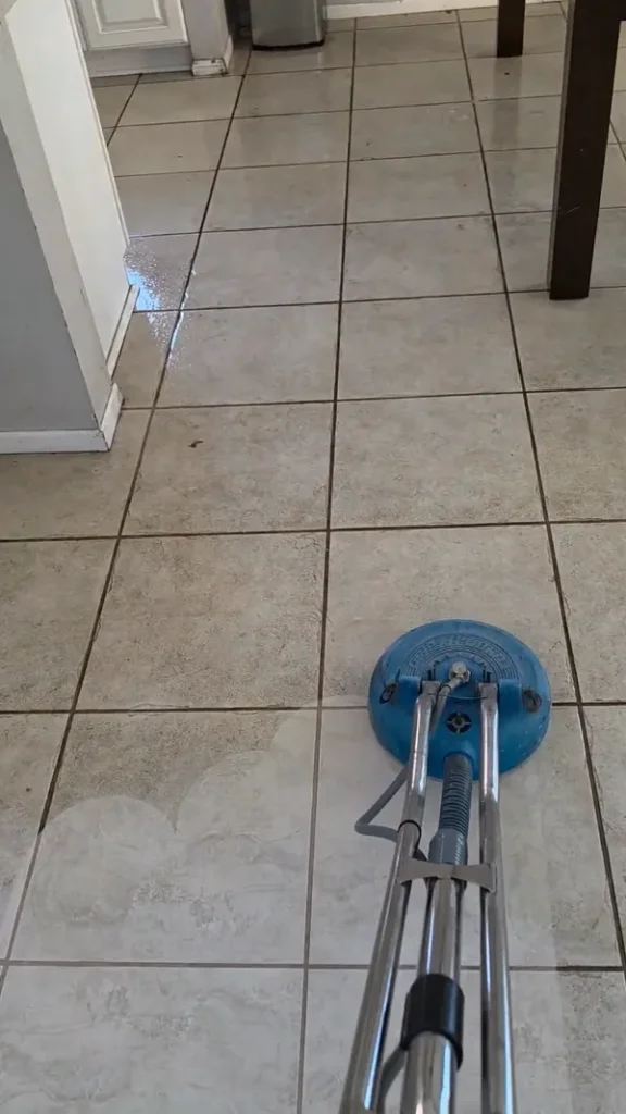 Commercial floor spinner leaving a bright, clean path on dirty tile flooring by removing soap residue