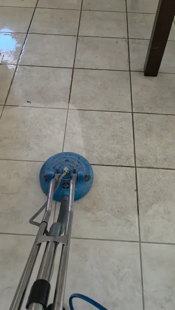 Professional floor cleaning wand leaving a bright, clean path on dirty tile flooring in Winchester