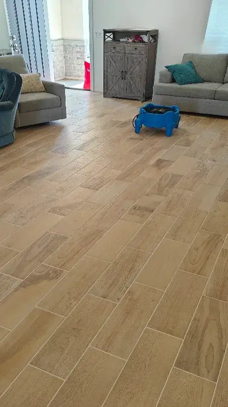 A view of a Wildomar, CA living room with professional wood-grain ceramic tile floor being dried by The Dirt Army's blue floor fan equipment after a deep clean
